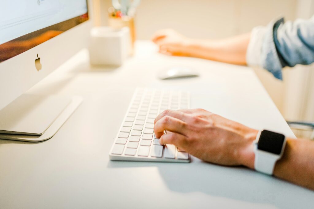 man typing on keyboard