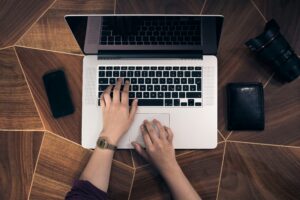 man typing on computer